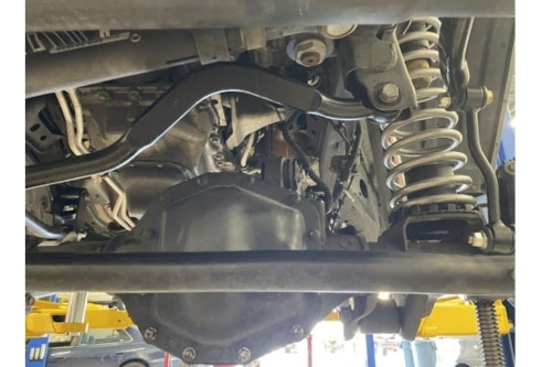 Car riding rough in Martinez, CA? Suspension issues and repair near me with Outlander Motorsports. Closeup image of a vehicle suspension system on vehicle that came into the shop for service.