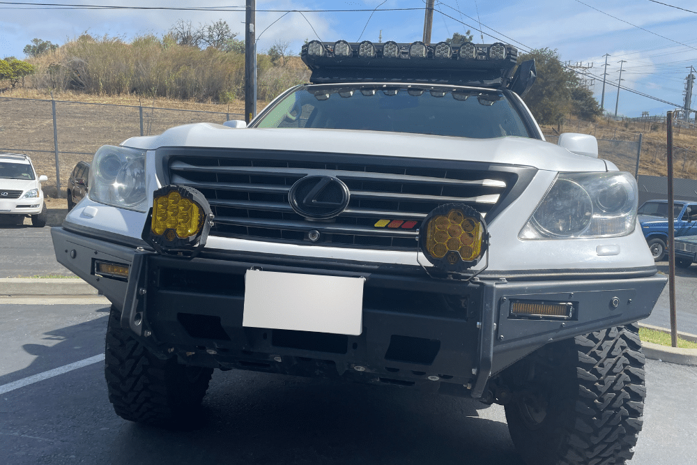 LED off-road lights, Off Road Specialist in Martinez, CA at Outlander Motorsport. Front view of a lifted Lexus SUV equipped with off-road modifications, including a custom bumper, yellow fog lights, roof-mounted light bar, and rugged tires.